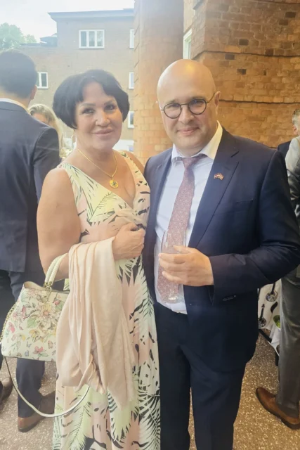 Annie Schur with Latvian Ambassador Dāvis Daudzvārdis attending an official reception in Oslo.